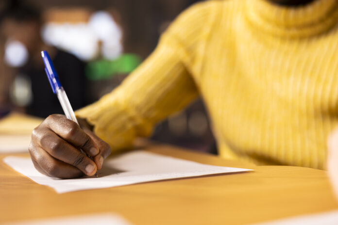 African american teen solving the school assignment for literature class lesson